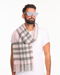 A father draping a grey cashmere scarf over his shoulders.
