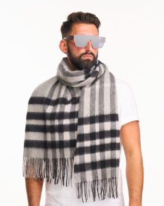 A grey cashmere scarf elegantly folded in a signature box.