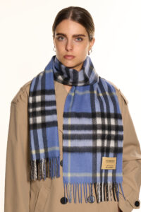 A mother wearing a luxurious cashmere scarf, showing elegance and warmth.