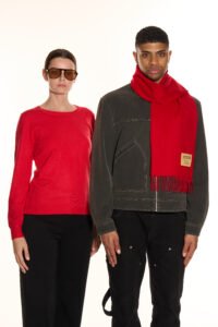 A vibrant flat-lay of red and gold-toned cashmere scarves arranged for a Chinese New Year gift presentation.