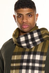 A close-up of an iconic red tartan cashmere scarf, symbolising prosperity and Scottish tradition.