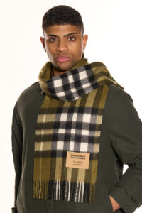 A folded navy tartan cashmere scarf.