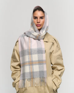 A folded red and black checked cashmere scarf in a luxury box.