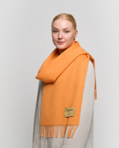 A folded tartan cashmere scarf in a signature Scottish gift box.
